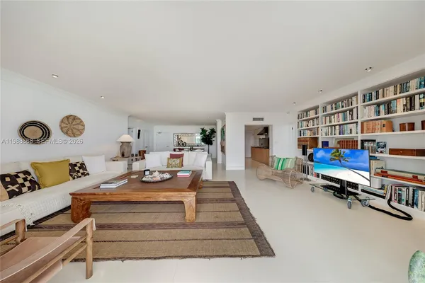 a living room with furniture and a book shelf