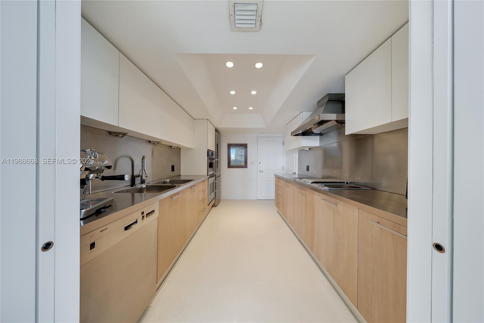 200 Ocean Ln Drive, Unit 1102 Key Biscayne, FL 33149 - Photo 9 of 24 a large kitchen with stainless steel appliances a sink and cabinets