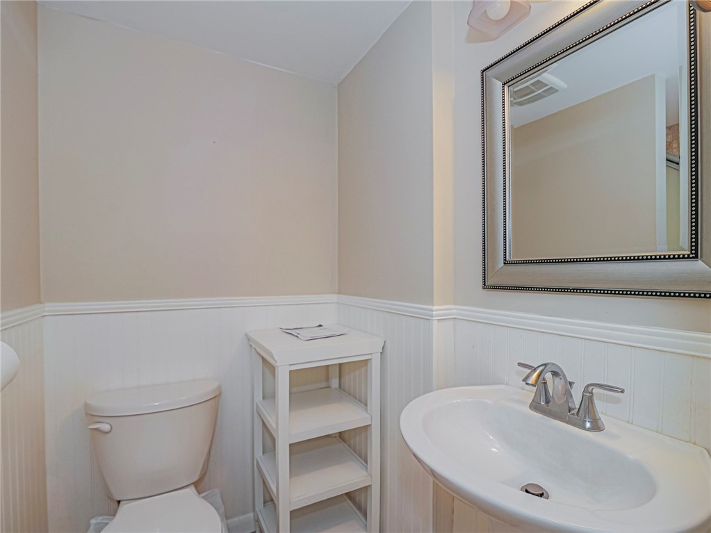 1860 Robalo Drive, Unit A105 Vero Beach, FL 32960 - Photo 21 of 35 a bathroom with a toilet a sink and mirror