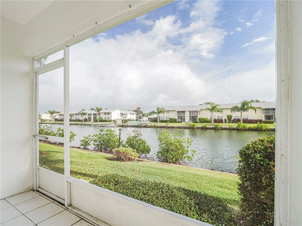 1860 Robalo Drive, Unit A105 Vero Beach, FL 32960 - Photo 23 of 35 a view of a lake with houses in the back