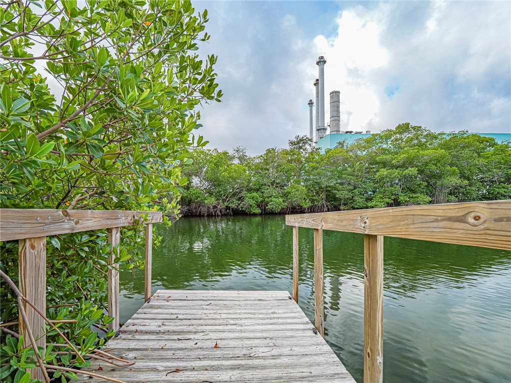 1860 Robalo Drive, Unit A105 Vero Beach, FL 32960 - Photo 28 of 35 a wooden bridge near lake