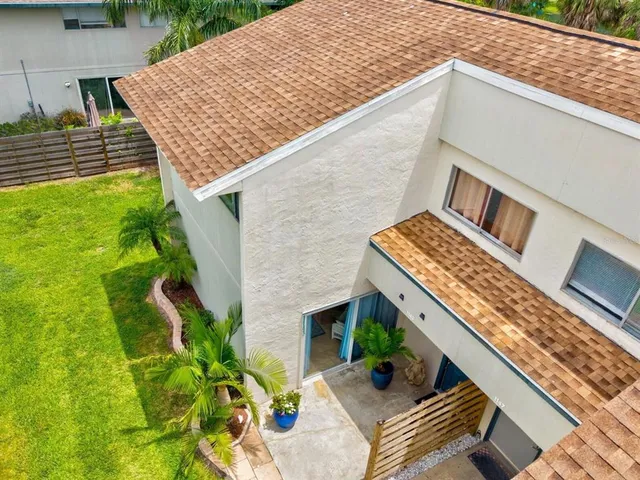 a potted plant sitting in front of a house