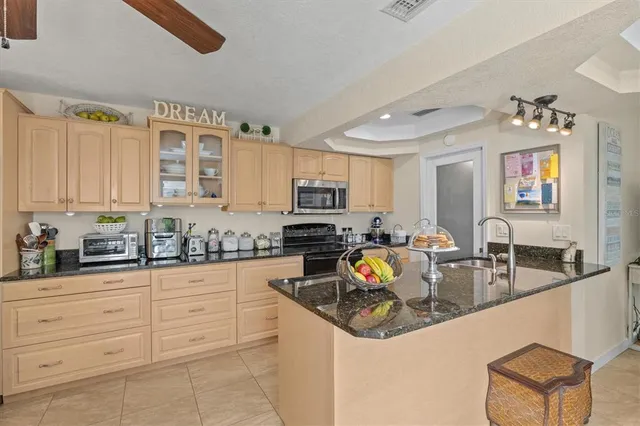 a kitchen with stainless steel appliances granite countertop a stove a refrigerator and a sink
