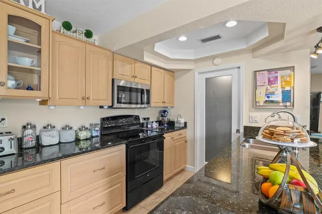 a kitchen with stainless steel appliances granite countertop a stove and cabinets