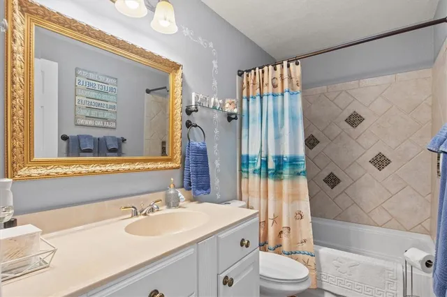 a view of a workspace with furniture and a flat screen tv