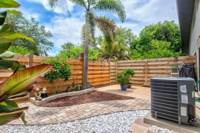 a view of a back yard of the house with a yard