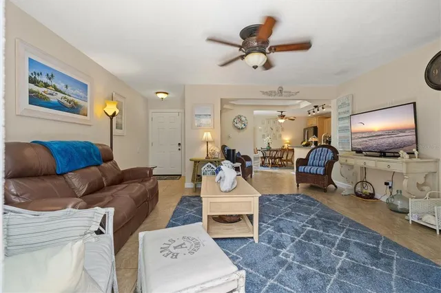 a living room with furniture a flat screen tv and a table