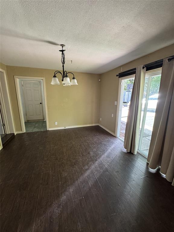 803 Ripley Avenue Ennis, TX 75119 - Photo 17 of 40 Spacious room featuring wood-finish flooring and neutral wall tones