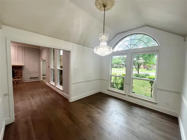 a view of livingroom with furniture wooden floor fan and a chandelier