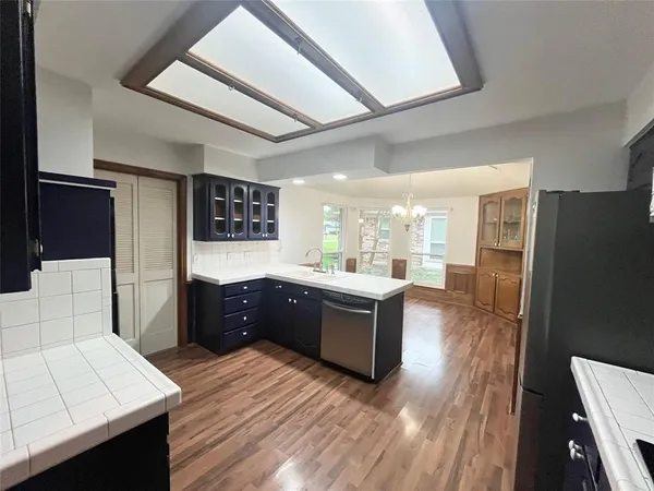 a large bathroom with a granite countertop sink a toilet a mirror and shower
