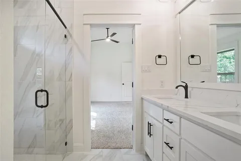 a bathroom with double sink and a mirror