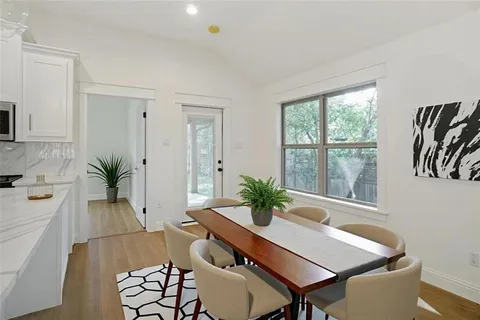 a dining room with furniture and window