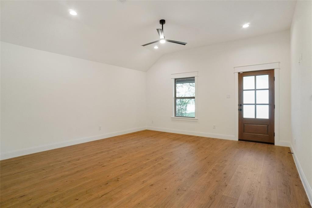 107 South 6th Street Godley, TX 76044 - Photo 8 of 21 wooden floor in an empty room with a window