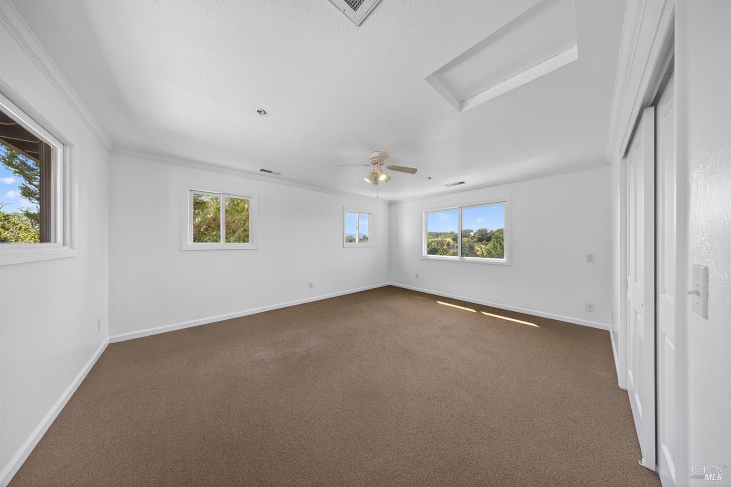 10 Lockton Lane Novato, CA 94945 - Photo 33 of 68 Spacious upper-level bedroom with natural light and flexibility for children, guests, or additional work-from-home needs.