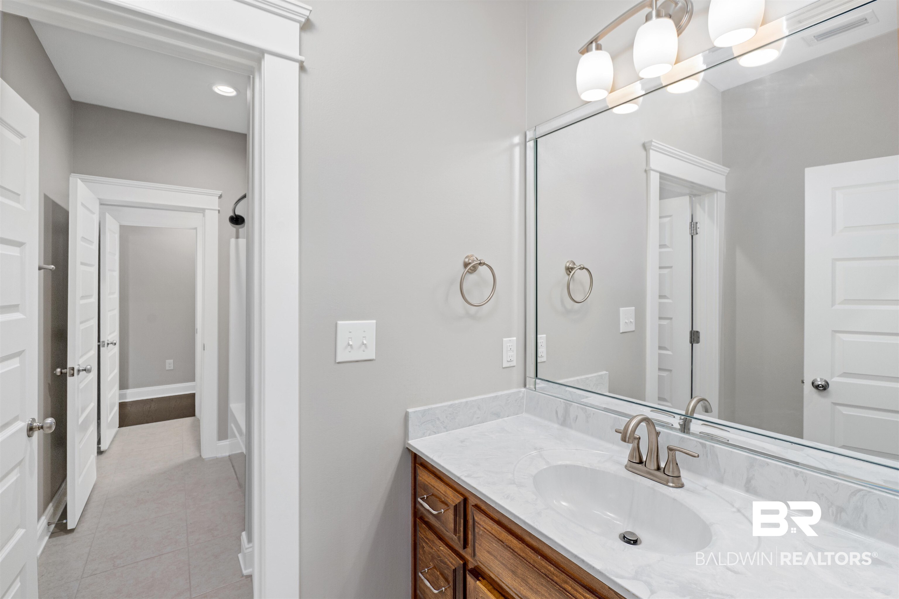24838 Slater Mill Road Daphne, AL 36526 - Photo 25 of 46 Full bathroom with vanity, light tile patterned flooring, and shower / tub combination