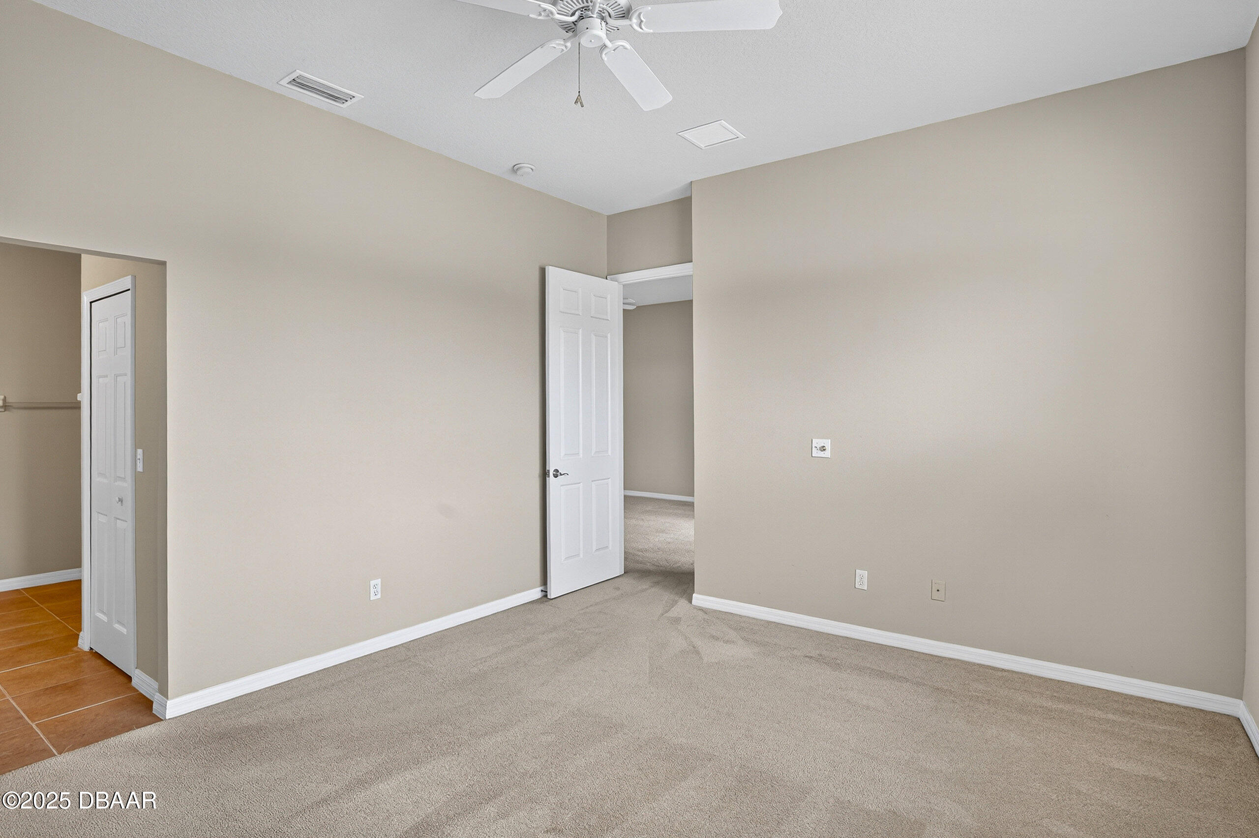 1312 Hansberry Lane Ormond Beach, FL 32174 - Photo 16 of 31 an empty room with a ceiling fan and a window