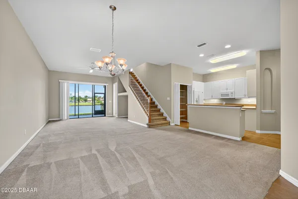 an empty room with a ceiling fan and a window