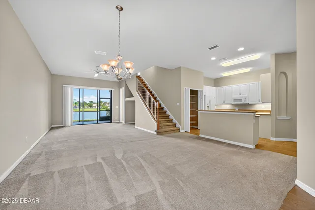 an empty room with a ceiling fan and a window