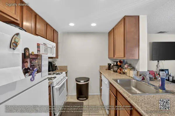 a kitchen with stainless steel appliances kitchen island granite countertop a sink stove and refrigerator