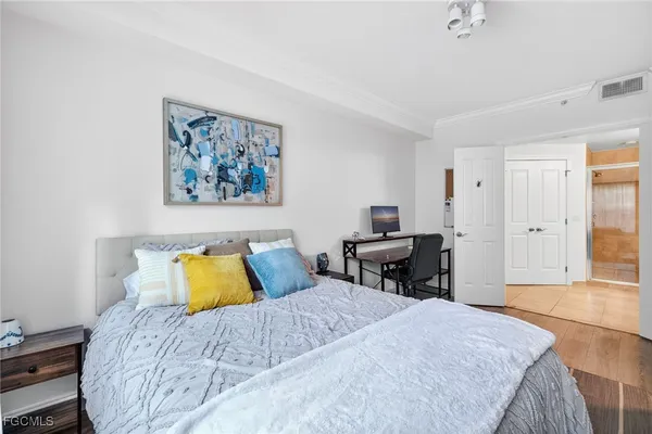 a bedroom with a bed and a table in it