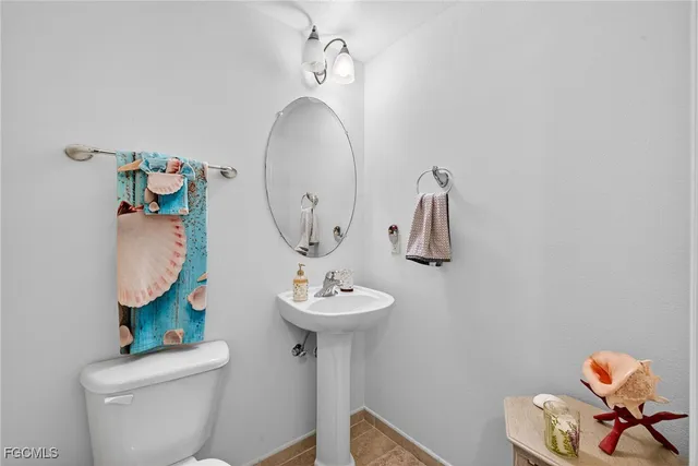 a bathroom with a sink mirror and toilet