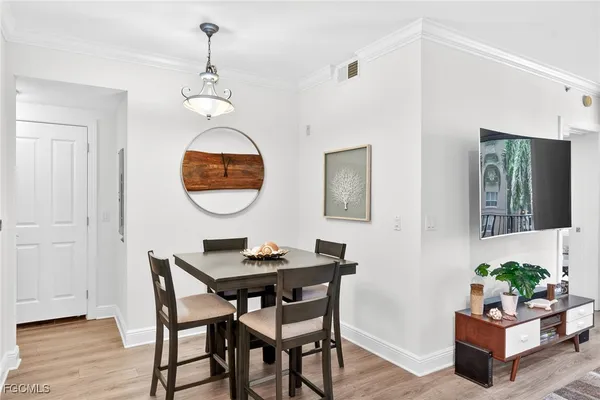 a dining room with furniture and wooden floor
