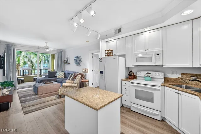 a kitchen with white cabinets and appliances
