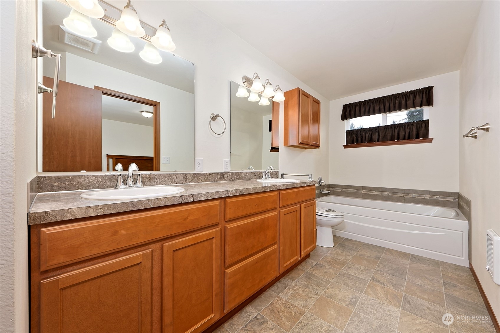 1025 Connection Street Shelton, WA 98584 - Photo 13 of 21 a bathroom with a sink a large mirror and a bathtub