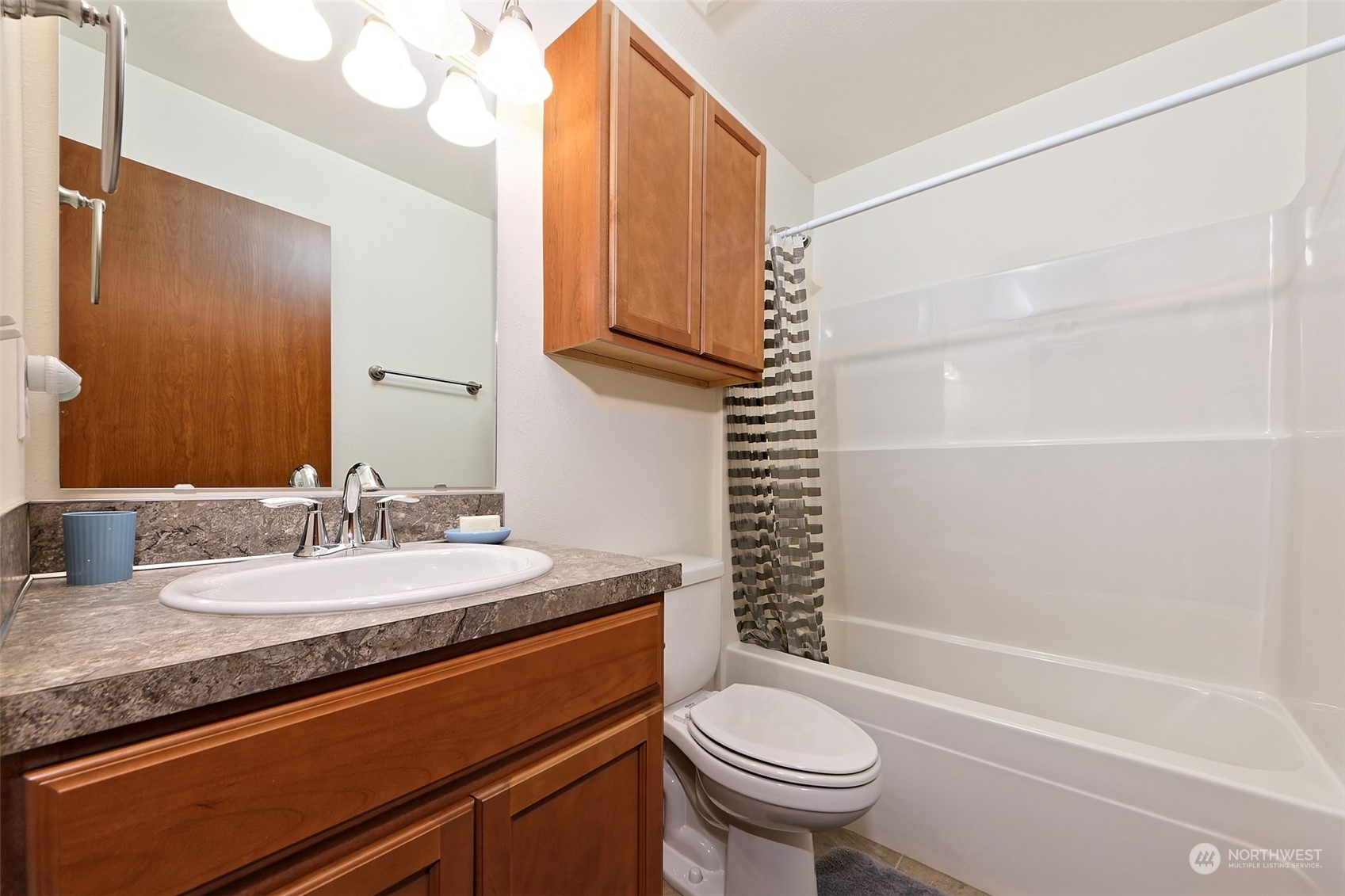 1025 Connection Street Shelton, WA 98584 - Photo 17 of 21 a bathroom with a granite countertop sink toilet and shower