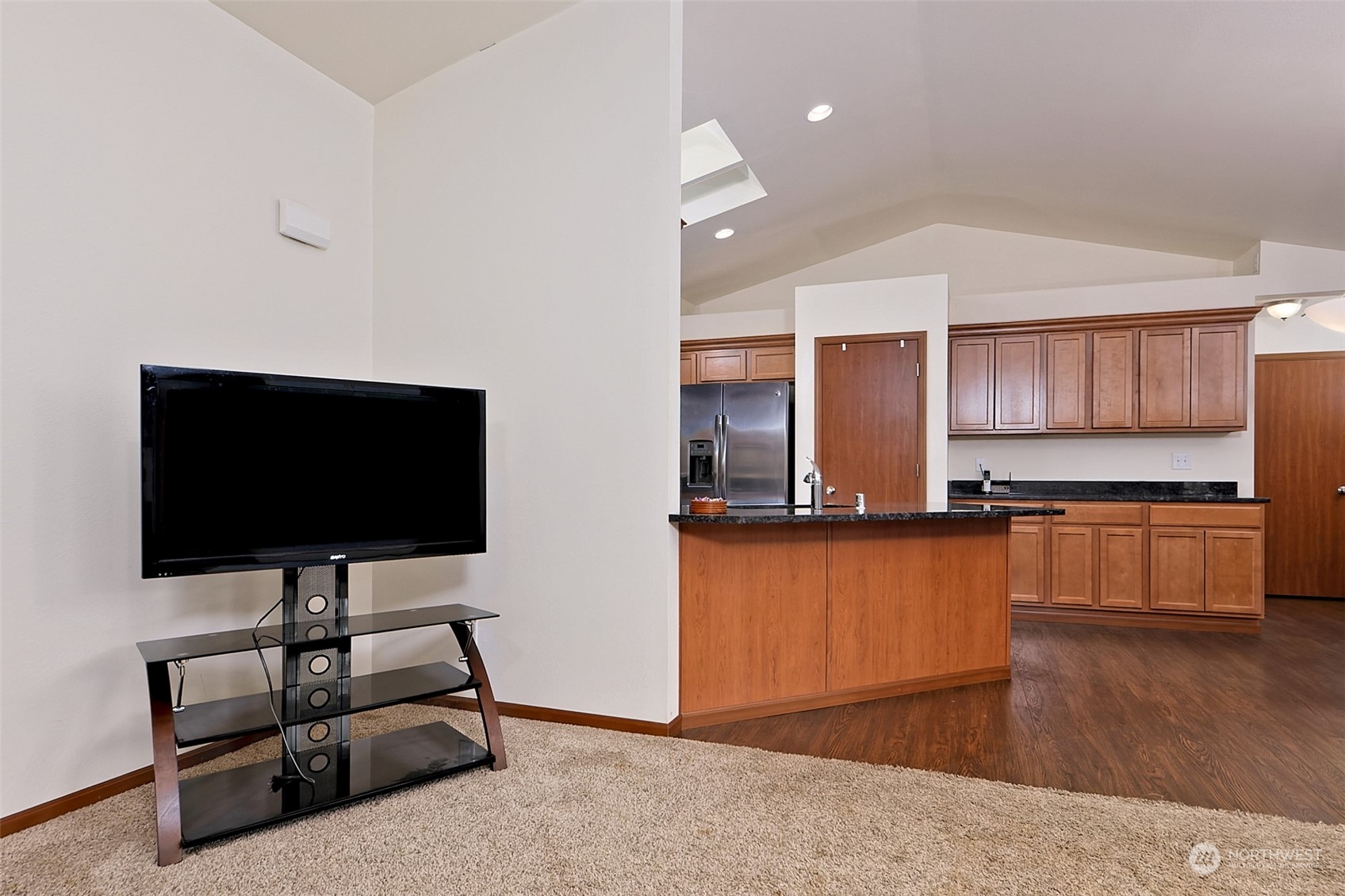 1025 Connection Street Shelton, WA 98584 - Photo 6 of 21 a living room with stainless steel appliances kitchen island granite countertop a refrigerator stove and a sink with wooden floor