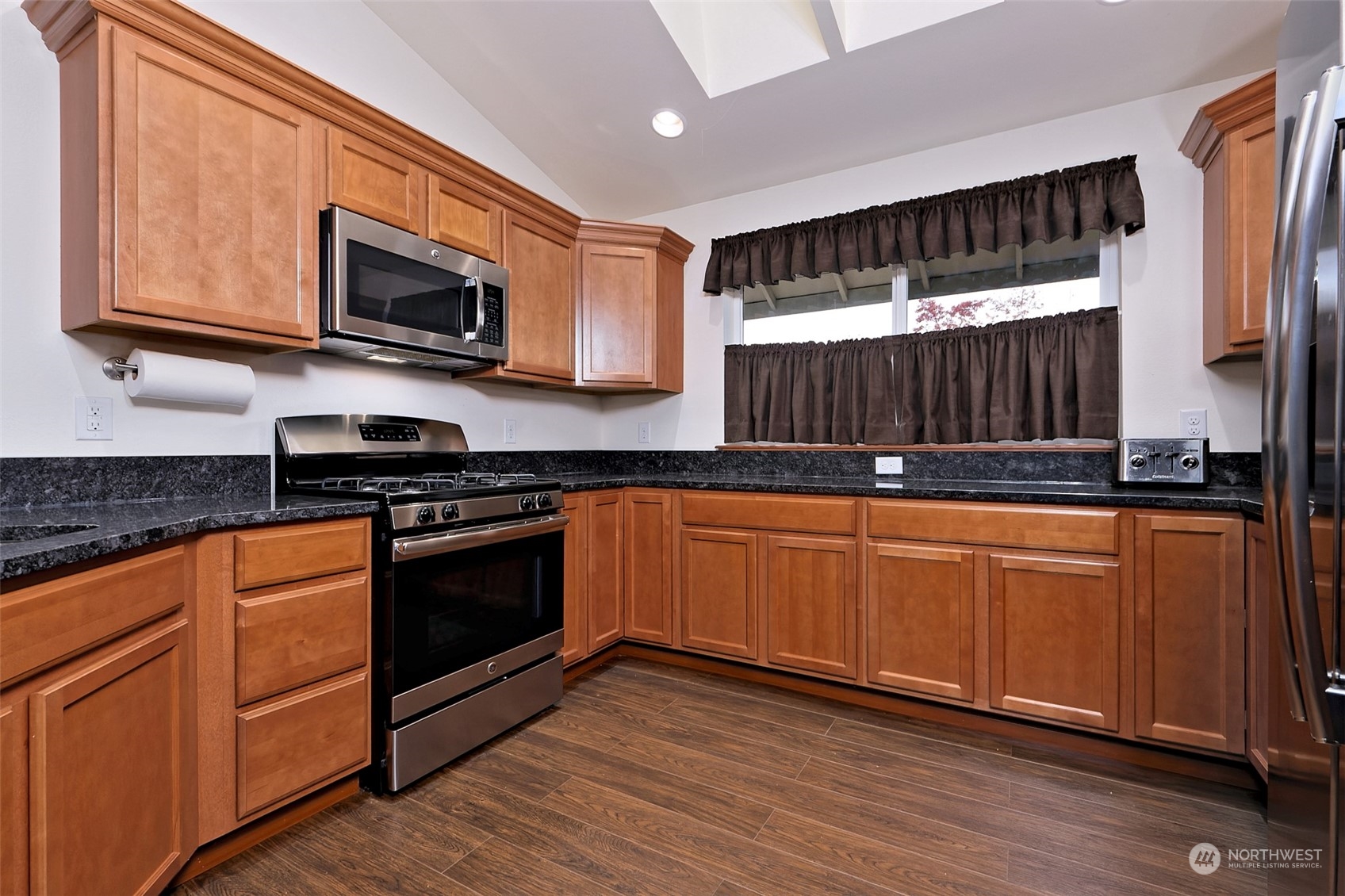 1025 Connection Street Shelton, WA 98584 - Photo 8 of 21 a kitchen with stainless steel appliances granite countertop a stove a sink and a microwave