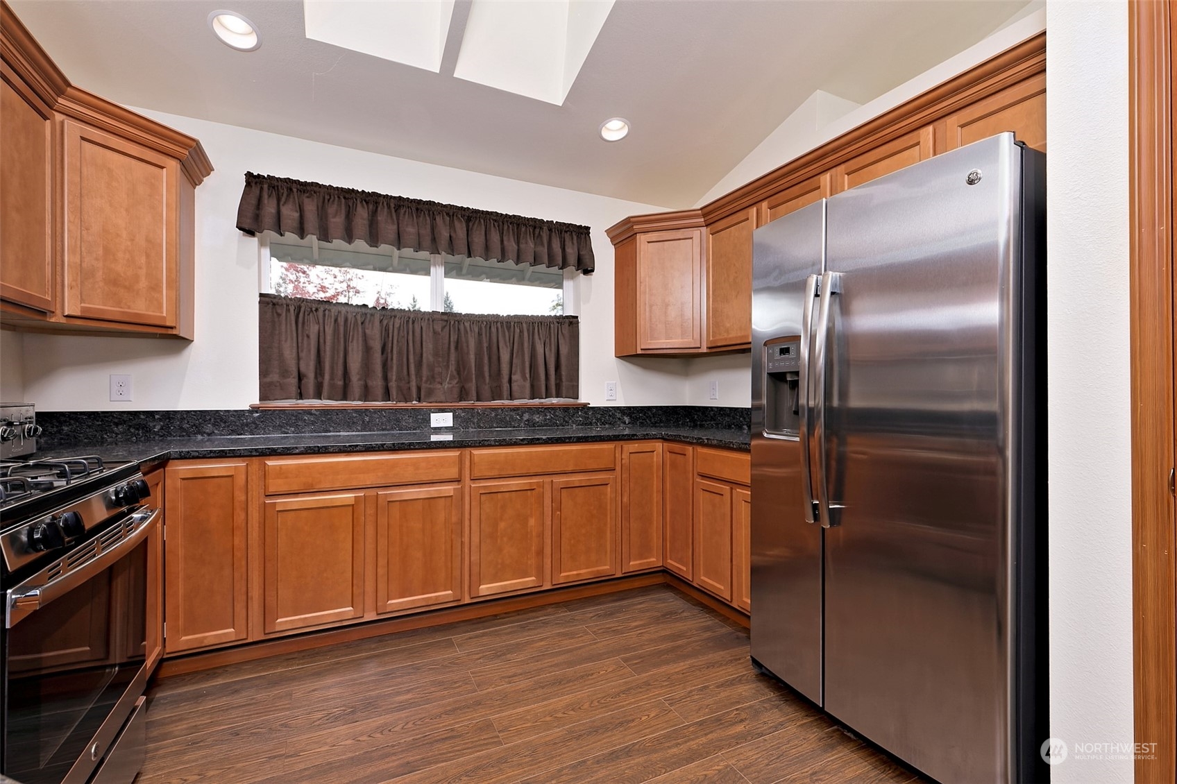 1025 Connection Street Shelton, WA 98584 - Photo 9 of 21 a kitchen with stainless steel appliances granite countertop a refrigerator a sink and dishwasher a stove with wooden floor