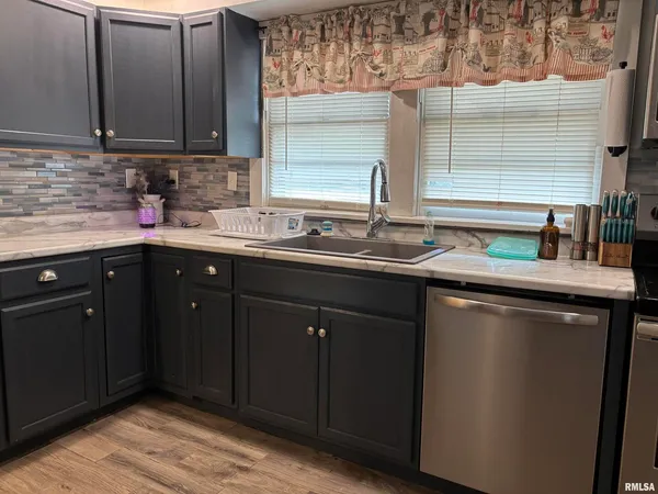 a kitchen with a sink and a window