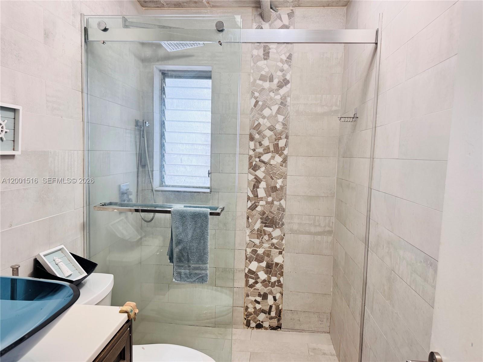 1340 Lincoln Road, Unit 805 Miami Beach, FL 33139 - Photo 14 of 21 a bathroom with a shower curtain and a sink