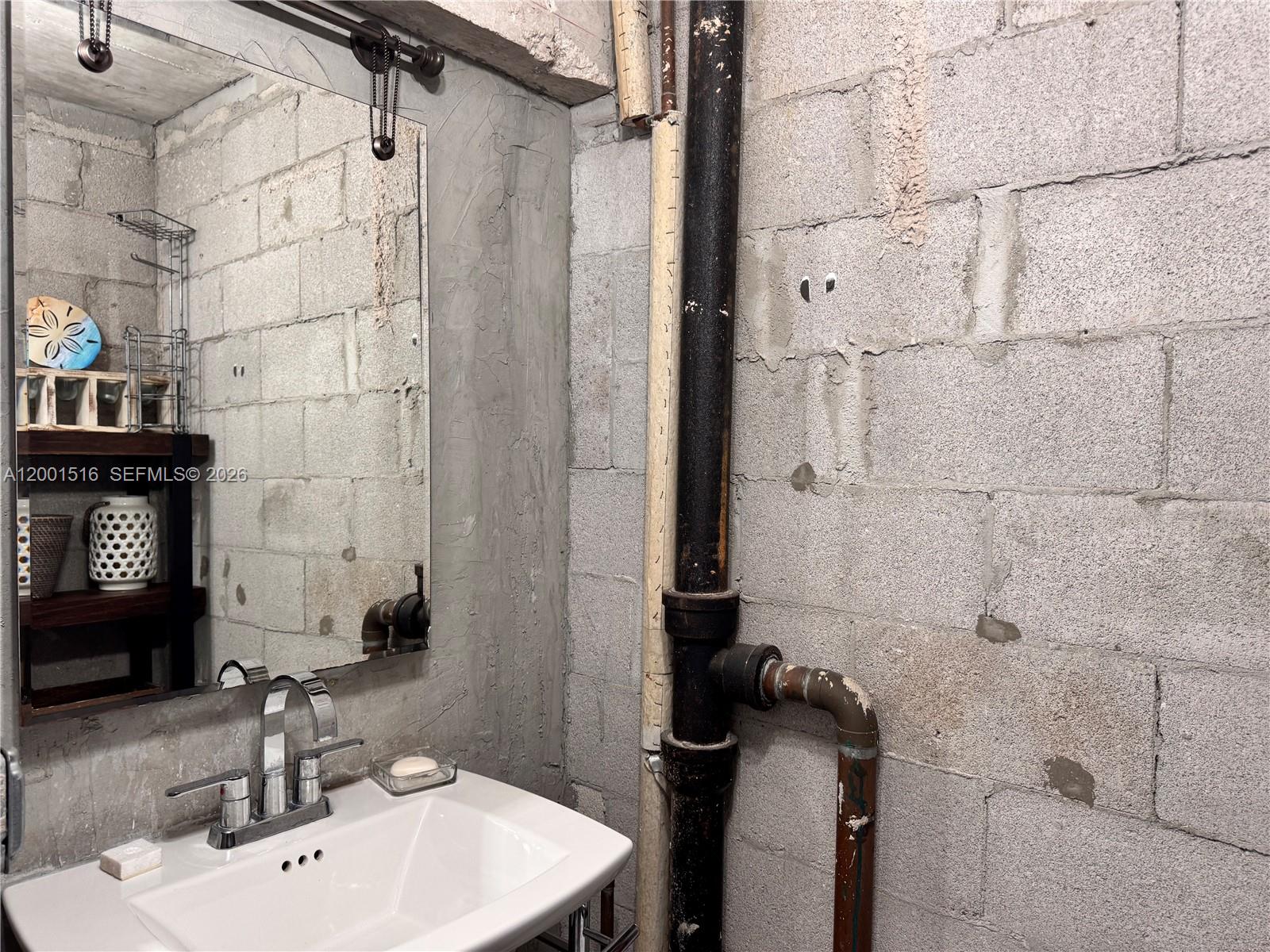 1340 Lincoln Road, Unit 805 Miami Beach, FL 33139 - Photo 16 of 21 a bathroom with a sink toilet and shower