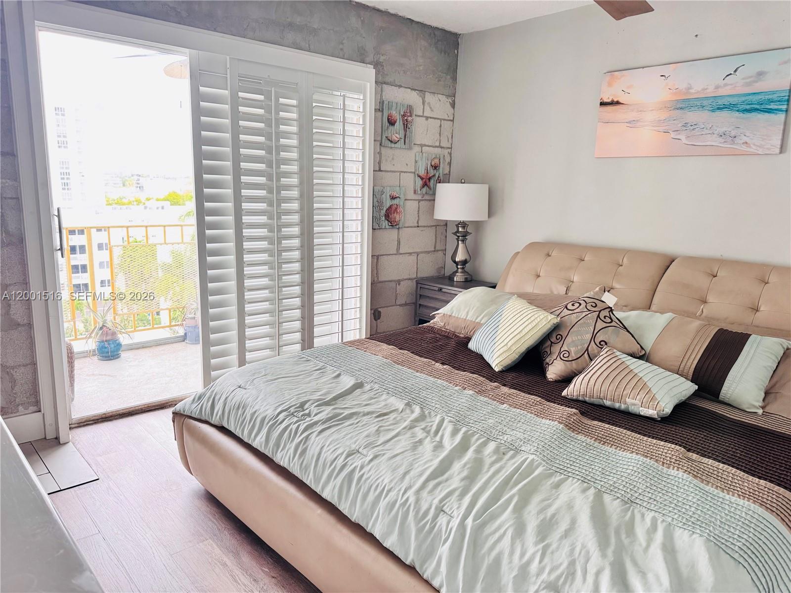 1340 Lincoln Road, Unit 805 Miami Beach, FL 33139 - Photo 19 of 21 a bedroom with a bed and a large window