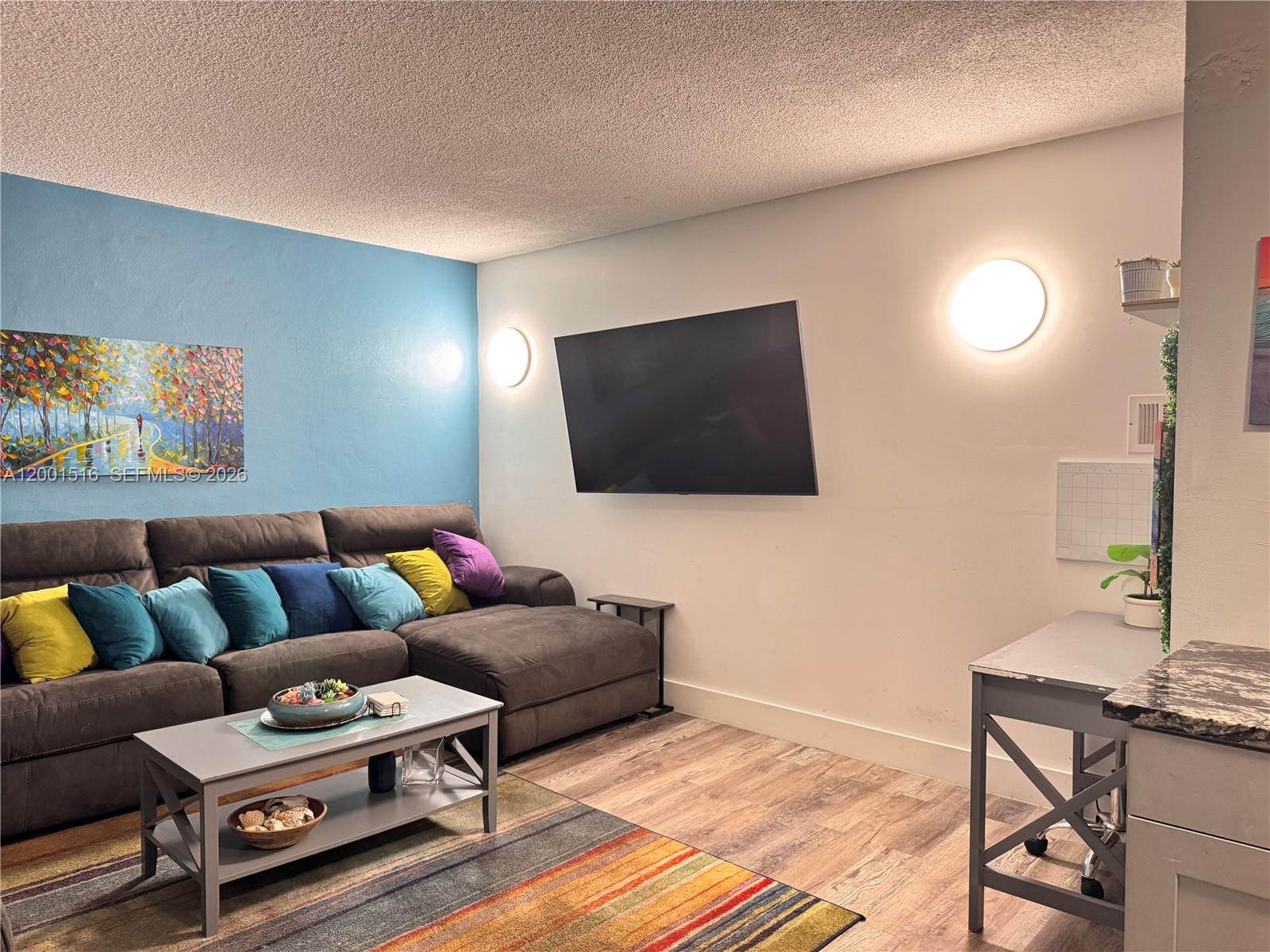 1340 Lincoln Road, Unit 805 Miami Beach, FL 33139 - Photo 6 of 21 a living room with furniture and a flat screen tv