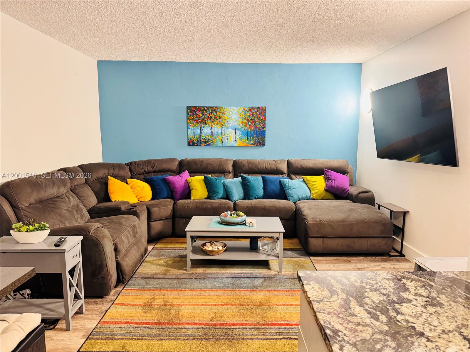 1340 Lincoln Road, Unit 805 Miami Beach, FL 33139 - Photo 8 of 21 a living room with furniture and a flat screen tv