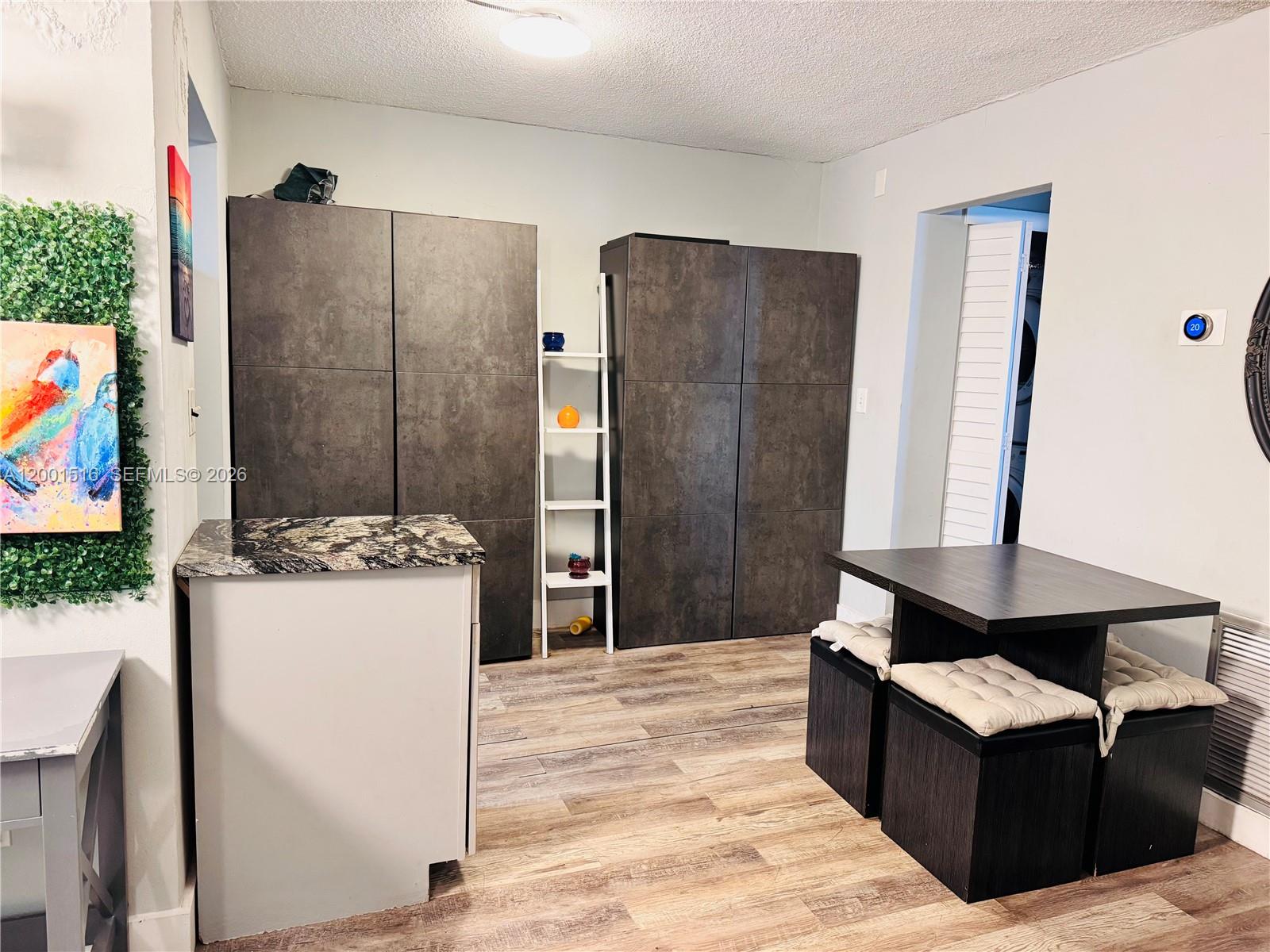1340 Lincoln Road, Unit 805 Miami Beach, FL 33139 - Photo 9 of 21 a living room with a couch and a refrigerator
