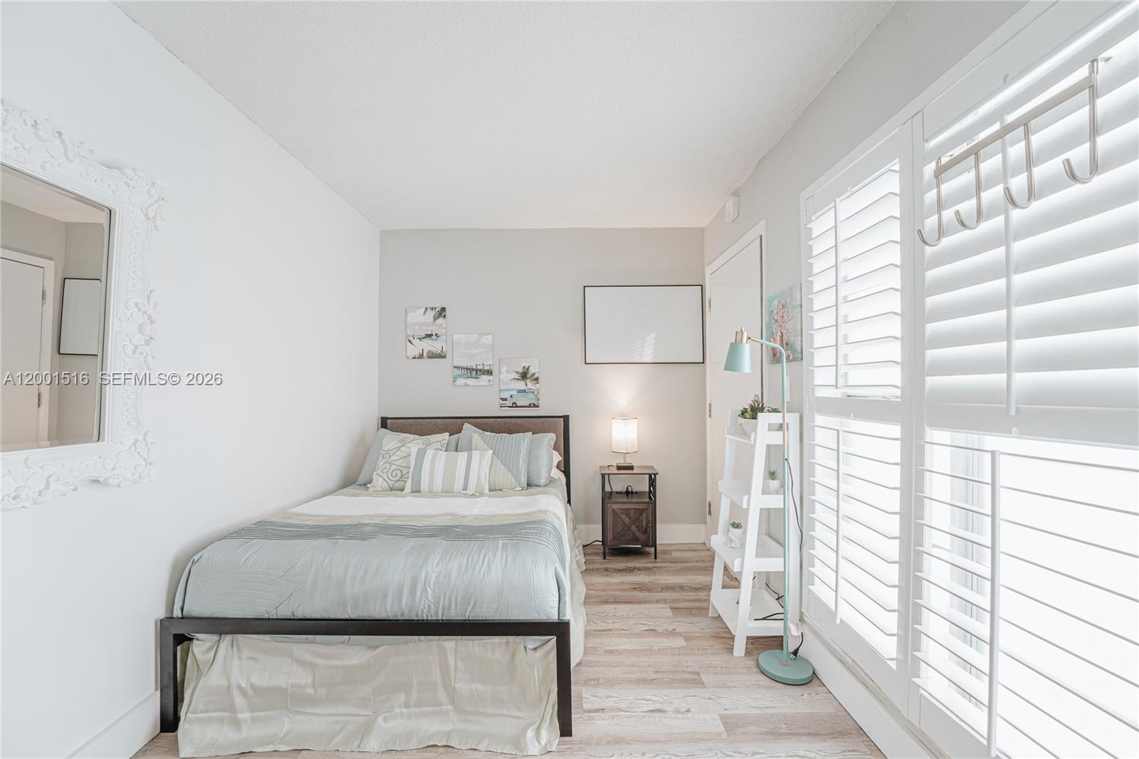 1340 Lincoln Road, Unit 805 Miami Beach, FL 33139 - Photo 10 of 21 a bedroom with a bed and a large window
