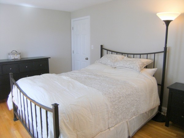 6 Gerald Road Framingham, MA 01701 - Photo 16 of 20 a large bed sitting in a bedroom next to a window with a dresser