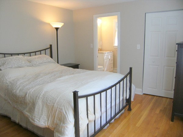 6 Gerald Road Framingham, MA 01701 - Photo 18 of 20 a bedroom with a bed and a chandelier