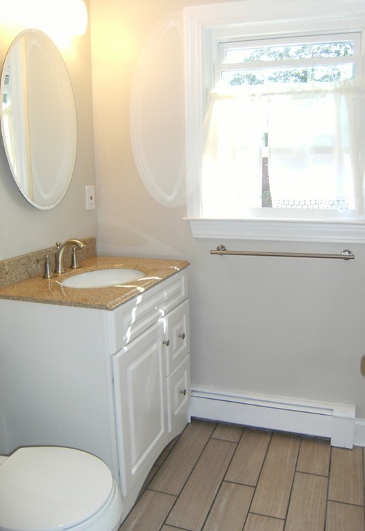6 Gerald Road Framingham, MA 01701 - Photo 19 of 20 a bathroom with a sink a toilet and a mirror