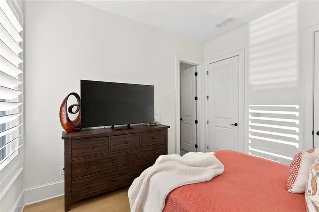 a view of a hallway with bedroom and balcony