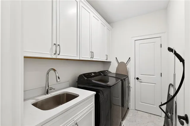 a spacious bedroom with a bed and a chandelier