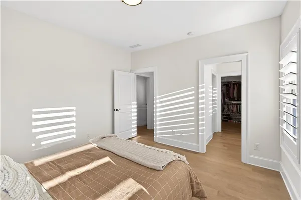 a view of a bedroom with an empty space and shelves
