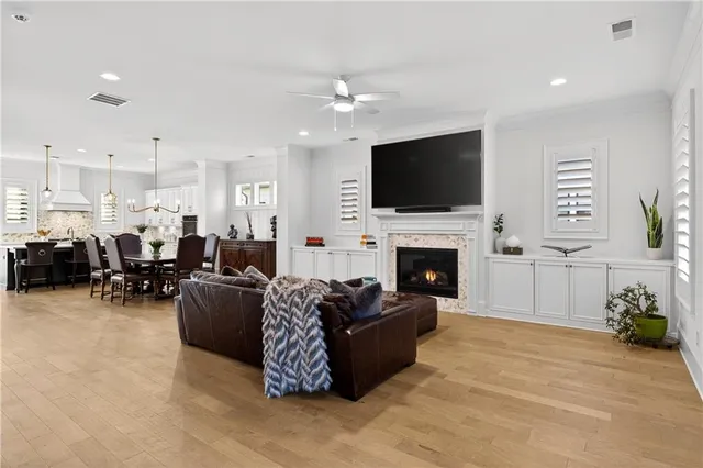 a living room with furniture a flat screen tv and a fireplace