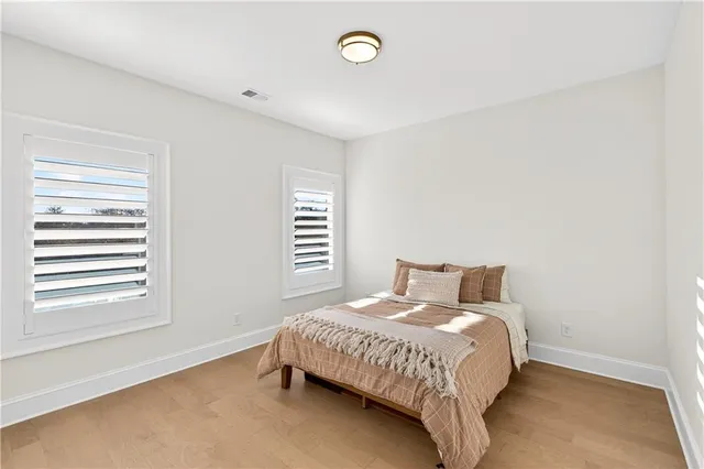 a view of a hallway with wooden floor and a chandelier