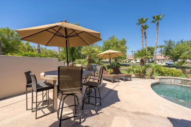 a view of a backyard with sitting area and furniture