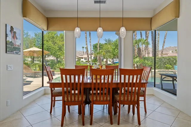 a view of a dining room with furniture window and outside view